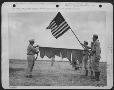 Consolidated > ITALY-Maj. Gen. Nathan Twining pins two presidential citation banners on guidon.