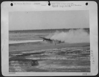 Thumbnail for Consolidated > This Picture Of A Consolidated B-24 Liberator Bomber, Taken As It Crash Landed At A 15Th Aaf Base In Italy, Was Snapped By Sgt. Joseph Leclair Of Lewiston, Mo., Photographer With The Group Photo Lab.  The Figure Shrouded By The Dust Of The Still Moving Pl