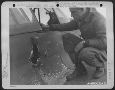 Consolidated > 2Nd Lt. G.R. Mcmoody Of Coldwater, Michigan, Pilot With The 79Th Fighter Group Based At Capodichino, Italy, Examines The Damaged Done To His Plane When He Was Jumped By 2 Fw-190S While Patroling The Beachhead.