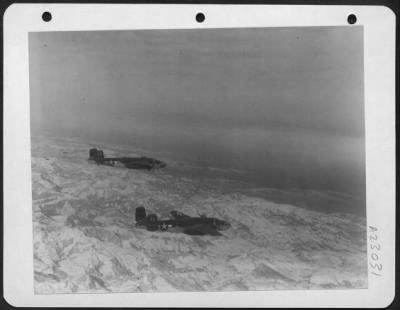 Consolidated > Two North American B-25 Mitchells Of The 12Th Af Over The Alps On Their Way To Their Targets.  Italy.