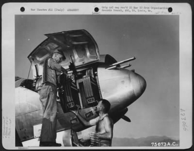 Thumbnail for Consolidated > Armorers Load Ammunition In The Nose Of A Lockheed P-38 Lightning Of The 94Th Fighter Squadron, 1St Fighter Group, At An Airfield Somewhere In Italy.