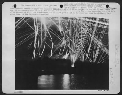 Thumbnail for Consolidated > These Brilliant Streaks Of Light Were Caused By Allied Anti-Aircraft Fire, Reaching Out For Raiding Nazi Planes Over Bari, On The Adriatic Coast Of Italy.  The Heavier, Wavy Streaks Were Caused By Flares From The German Craft.  In Spite Of The Darkness Of