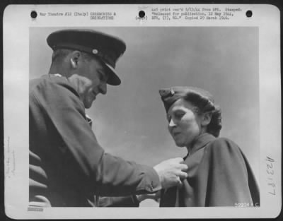 Consolidated > Major General Nathan F. Twining, Commanding Gen. Of The 15Th Aaf In Italy, Is Shown Here Presenting The Soldiers Medal To 2Nd Lt. Christine Dahl, Of 3026 S. California, Chicago, Ill.  Lt. Dahl, A Nurse Assigned To A Field Hospital In Southern Italy, Was A