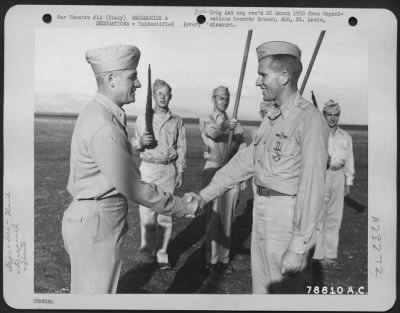 Consolidated > Major General Nathan F. Twining Presents The Distinguished Flying Cross To A Member Of The 94Th Fighter Squadron, 1St Fighter Group During A Ceremony At An Airbase Somewhere In Italy.