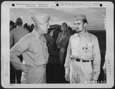 Consolidated > Major General Nathan F. Twining Presents The Distinguished Flying Cross, Air Medal And The Purple Heart To A Member Of The 94Th Fighter Squadron, 1St Fighter Group During A Ceremony At An Airbase Somewhere In Italy.