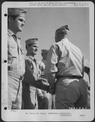 Consolidated > Major General Nathan F. Twining Presents An Award To A Member Of The 94Th Fighter Squadron, 1St Fighter Group During A Ceremony At An Airbase Somewhere In Italy.