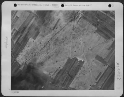 Thumbnail for Consolidated > After the airdrome at Villaorba had had a dose of "daisy cutters," the fragmentation bombs dropped by heavy bombers, funeral pyres like the one in the lower left corner rose from the field above the smashed wrecks of Jerries caught by the raid.