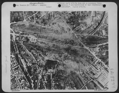 Thumbnail for Angouleme > Sprawled freight cars, disrupted tracks and damaged building from direct hit are revealed at Angeuleme rail marshalling yard, 70 miles north of Bordeaux, France after attack by 8th USAAF bombers.