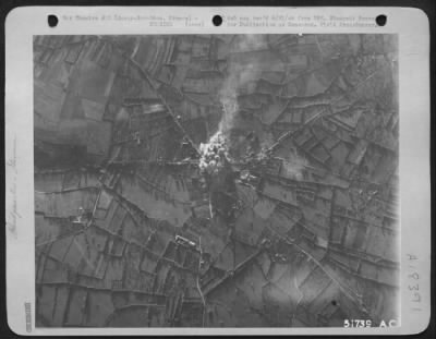 Thumbnail for Aunay-Sur-Odon > One divisional German Hdqs., believed to be at Aunay-Sur-Odon, France, was peppered by 9th Air Force Douglas A-20 Havocs with bombs which show in photo as a good concentration of explosions. By day and by night the Nazi military machine is