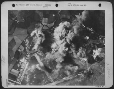 Thumbnail for Avord > Photo shows bombs from Consolidated B-24 Liberators blanketing the airfield at Avord, France. Smoke billows upward as bomb bursts smash repair shops, hangars and administration buildings.