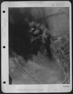Dijon > Billows of smoke shrouds the Luftwaffe's twin-engine fighter base at Dijon in eastern France as American heavy bombers took their toll of four hangars damaged or destroyed and hits on the main workshops, three smaller hangars and the barracks area