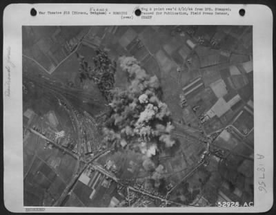 Thumbnail for Hirson > "Son of Satan" led the group to make this strike on the railroad yards at Hirson, Belgium. Photo reconnaissance after the smoke had cleared showed a crater about 45' wide and 150' long where an ammunition train had been destroyed.