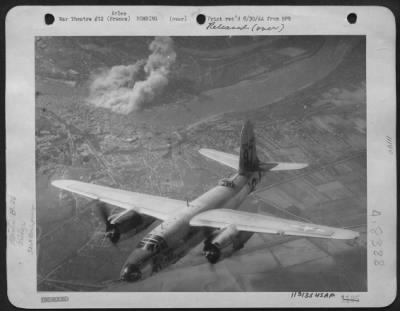 Thumbnail for Arles > One Of The Marauders Of The Tactical Air Force Over Southern France On "D' Day.  This Silver Martin B-26 Marauder Bomber Is Seen Headed Home, With The Smoke Covered Road Bridge Across The Rhone River At Arles In The Background.