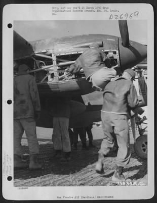 Thumbnail for Consolidated > Mechanics of the 94th Fighter Squadron, 1st Fighter Group work on the engines of a Lockheed P-38 at their air base in Sardinia.