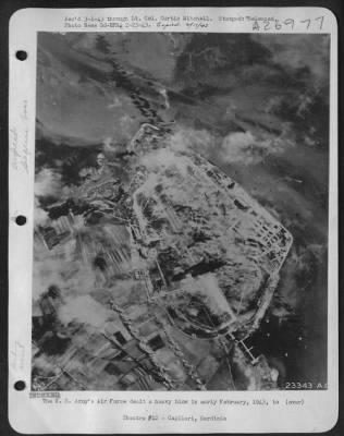 Thumbnail for Consolidated > The U.S. Army's Air Force dealt a heavy blow in early February, 1943, to the airdrome and seaplane base at Cagliari, Sardinia. Striking in broad daylight, Flying Fortresses and Martin Marauder bombers showered the Axis fields with high explosive and