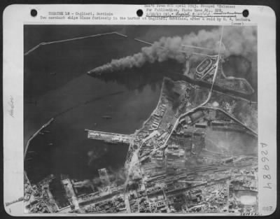 Thumbnail for Consolidated > Two merchant ships blaze furiously in the harbor at Cagliari, Sardinia, after a raid by U.S. bombers.