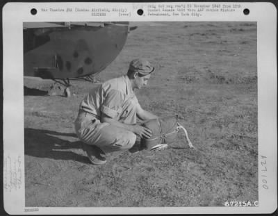 Thumbnail for Consolidated > A parachute rigger will attach this parachute arrestor to the tail of a glider participating in the 52nd Troop Carrier Wing maneuvers at Comiso Airfield in Sicily. 1943.