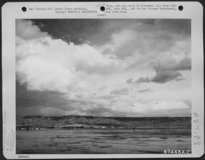 Thumbnail for Consolidated > After releasing gliders (Waco CG-4's) tow planes (Douglas C-47's) drop the paratroopers which they have carried as well as towing gliders which participated in the 52nd Troop Carrier Wing maneuvers over Sicily in 1943. The gliders were also loaded