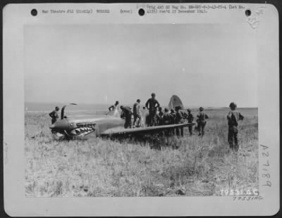 Thumbnail for Consolidated > A Curtiss P-40 used by the RAF, is shown after it made a crash landing near San Stephano, Sicily. The plane was hit by anti-aircraft fire and large shells which on a strafing mission over German lines. 3 August 1943.