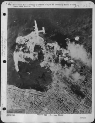 Thumbnail for Consolidated > A B-24 Liberator of the Ninth U.S. Army Air Force, poised above Messina, Sicilian Terminus of the important Reggio-Messina ferry line, observes the effect of bomb bursts among naval barracks and oil tanks in the strategic Axis port. The liberators on