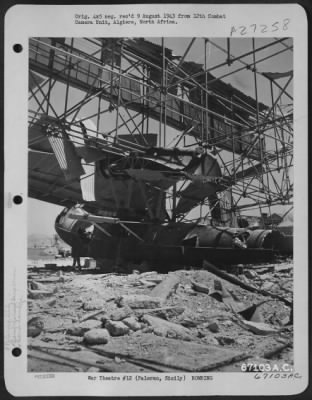 Thumbnail for Consolidated > American soldiers found a wrecked Italian seaplane inside a bombed-out hangar when they landed at Palermo, Sicily. July 1943.