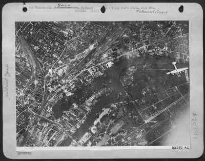 Thumbnail for Consolidated > One of the attacking Consolidated B-24 Liberators of the U.S. 8th AF roars over the Friedrichsfelde district of central Berlin 21 June 44 as initial bursts erupt on the rail marshalling yards there. Bombardment Group.