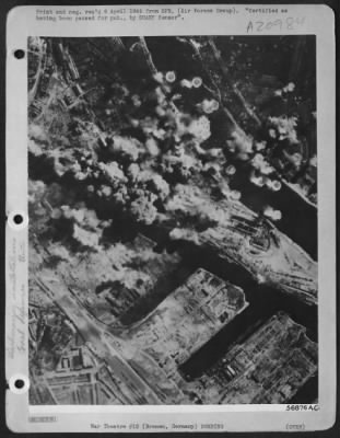 Thumbnail for Consolidated > GOOD VIEW OF BREMEN---Aided by perfect visibility, bombs of the 381st Bombardment Group strike at submarine pens and harbor installations at Bremen, Germany, 30 Mar. 45. This was one of several targets hit by a force of more than 1400 Consolidated