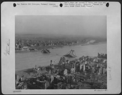 Thumbnail for Consolidated > General view of damage inflicted upon Cologne by repeatedly heavy Allied air assaults is recorded in this photo taken by a 9th AF photographer advancing along with Gen. Hodges First Army. One of the knocked out bridges wallow in the Rhine.