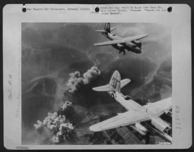 Thumbnail for Consolidated > Striking in aerial cooperation with the 7th Army offensive into the Saar Palatinate, American Martin B-26 Marauders of the 1st Tac. AF leave gushing clouds of smoke hovering over the German town of Erlenbach, an enemy strong point in the Siegfried