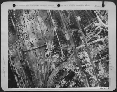 Consolidated > The Karlsruhe rail marshalling yards, carriage shops, roundhouse and wagon and machine shops were partially gutted by the U.S. 8th AF bomber attack on 9 August 44. It is located about 38 miles northwest of Stuttgart, Germany. Photo taken by an 8th AF