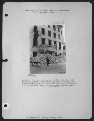 Thumbnail for Consolidated > Aviation Writers Under Balcony Where Hitler Made All Of His Famous Nazi Promises.  Note Wooden Barricade On Balcony Where Germans Had Strong Point During Street Fighting.  In Foreground Is Old German Woman Talking To Maj. Spaeth - Wright Fld.