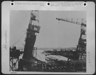 Consolidated > Floating Dock No. 5 At Deschimag'S Bremen U-Boat Yard, Still Holding Two Ruptured Submarines, Lies Canted On Its Side And Slowly Rolling, Waving The Two Travelling Cranes Back And Forth, As The German Cameraman Snapped The Shutter Late In Feb. 1945, After