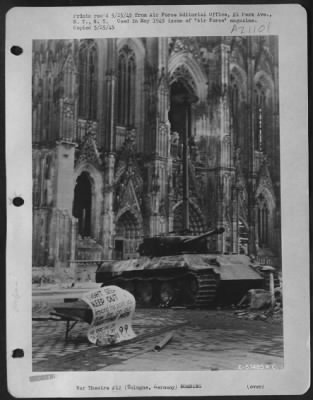 Thumbnail for Consolidated > With A Blasted [Panzerkampfwagen V Panther Sd.Kfz. 171] Tank Beside It And A Sign Warning Sightseers Not To Approach Closer, The Cathedral Maintains Its Watch On The No Longer Sacred Rhine.  Scarred By Blast, It Escaped A Direct Hit By Any Of The 42,000 T