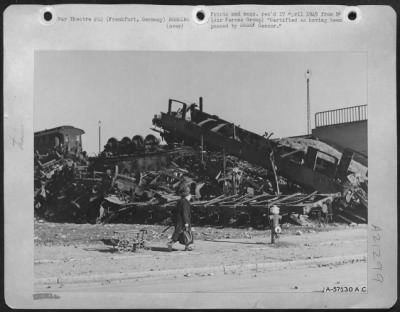 Consolidated > The Germans, Who Once 'Rode Hige, Wide And Handsome' As They Say In Texas, Today Walk Around The Ruins Of Upturned And Blasted Railroad Cars At Frankfurt, Germany, Pulling An Empty Cart.