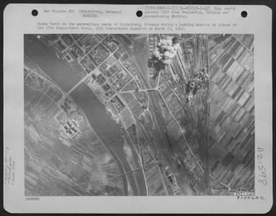 Thumbnail for Consolidated > Bombs Burst On The Marshalling Yards At Heidelberg, Germany, During A Bombing Mission By Planes Of The 17Th Bombardment Group, 34Th Bombardment Squadron On March 23 1945.