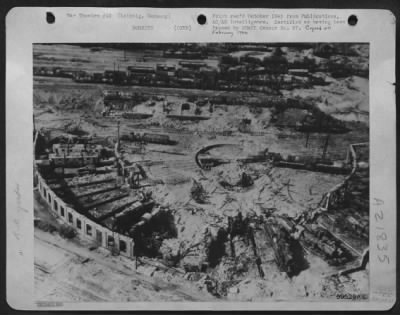 Consolidated > The Gutted Remains Of Several Locomotives Lie In The Dust Covered Debris Of A Roundhouse In A Leipzig, Germany, Marshalling Yard.  The Turntable Has Been Pin Pointed By Allied Bombing.