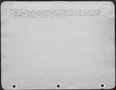 Consolidated > B-29 Bombs Over Burma (No.1) - Tons Of Bombs Speckle The Sky Over Rangoon, Burma, As They Spew From The Yawning Bomb Bays Of 20Th Bomber Command Superfortresses.  The Target Of This Daylight Attack By Brig. Gen. Roger M. Ramsey'S India-Based Airman Was A