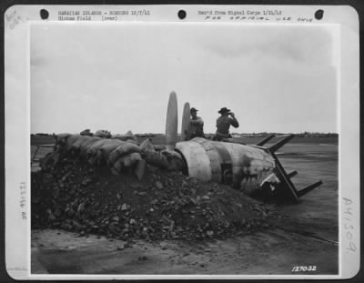 Thumbnail for Consolidated > First Army Photos Of The Bombing Of Hawaii, Dec. 7, 1941.   Soliders On Lookout For Enemy Planes In Make-Shift Machine Gun Nest Made From Bomb Crater And Motors From Destroyed Planes.  Hickam Field, T.H.