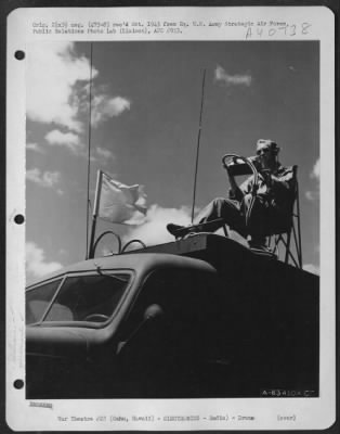 Consolidated > Metal Stick Operator T/Sgt. L.D. Arris Of 1017 W. 3Rd St., Los Angeles, Calif., Guides A Radio Controlled Plane From His Position On Top Of Radio Control Truck.  Oahu, Hawaii, April 1945.  (Wheeler Field).