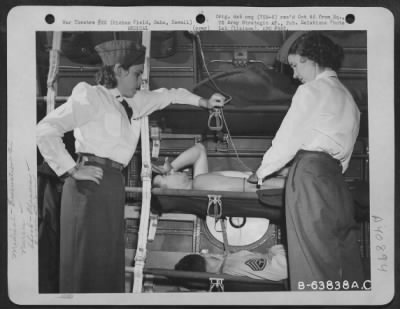 Thumbnail for Consolidated > Light Nurses Administer Blood Plasma To Patients Aboard An Evacuation Plane At Hickam Field, Oahu, Hawaii, 12 July 1944.