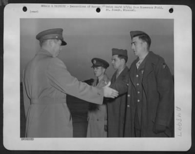 Thumbnail for Groups > Receives Awards - Lt. Colonel William B. Hooton, Commanding Officer, Rosecrans Fields, 1St Operational Training Unit, Ferrying Division, Atc, St. Joseph, Mo., Congratulates Sgt. Francis W. Whitley Of Jerseyville, Ill., After Presenting The Sgt. With The D