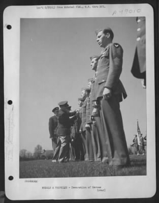 Thumbnail for Groups > Combat Crew Member, Sergeant Welton K. Fulton Flew In Service Overseas, Wears Ribbon For European Theater Operations. Now He Wins The Air Medal, Pinned On Here By Brigadier General Westside T. Larson At Mitchel Field, New York, Ceremonies. The Blue-And-Go