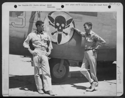 Thumbnail for Groups > 1Lt James W. Welsh, Jr., Of St. Augustine, Fla., Co-Pilot And 1Lt John E. Mcatee, Of San Francisco, Calif., Pilot, Lean Against Side Of One Of The B-24S They Fly On Combat Missions.  Between Them Is Shown The Skull And Crossbone Insignia Of Their Squadron