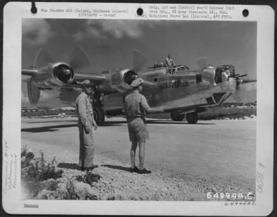 Consolidated > Major General Robert W. Douglass, Jr. (Right) And Colonel Lawrence J. Carr Watch The Consolidated B-24 Liberator 'Bolivar Jr.' As It Taxies To Hardstand On Saipan, Marianas Islands, 19 May 1945.