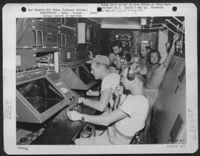 Thumbnail for Consolidated > When Bad Weather Cuts Visibility To A Minimum, 'Zippo', A High Precision Radar Device, Insures A Safe Landing To Incoming Aircraft At Harmon Field, Guam Air Depot, Guam, Marianas Islands.  Operators At The Cathode-Ray Screens And Controls Contact The Plan