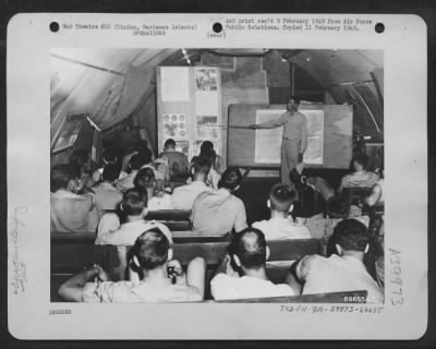 Consolidated > Tinian Island, Marianas Islands - Members Of The 509Th Composite Group Attend A Briefing Conducted By Capt. Joseph Buscher And Lt. Charles Levy In Preparation For The First Atomic Bombing On Hiroshima, 6 August 1945.