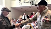 Thumbnail for Grand marshal Joe Schachter asked all the veterans in the auditorium to stand. Bob Satter and Sam Brody delightedly shook hands..jpg