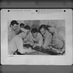 China-Pilot and S-2 Officer watch as photo-interpreters pick negatives for rush printing for first phase interpretation. - Page 1